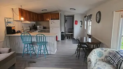 a kitchen and living room with a table and chairs at Charming Countryside Retreat in Fort Plain