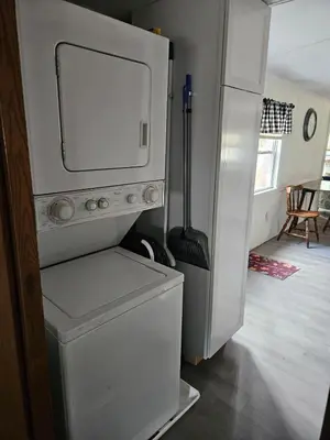 a kitchen with a refrigerator and a washing machine at Charming Countryside Retreat in Fort Plain
