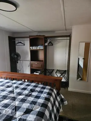 a bedroom with a bed and a mirror and a closet at Charming Countryside Retreat in Fort Plain