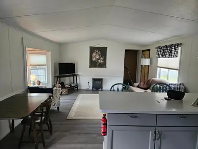 a kitchen and living room with a table and a couch at Charming Countryside Retreat in Fort Plain