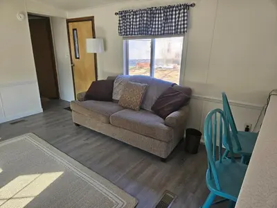 a living room with a couch and a window at Charming Countryside Retreat in Fort Plain