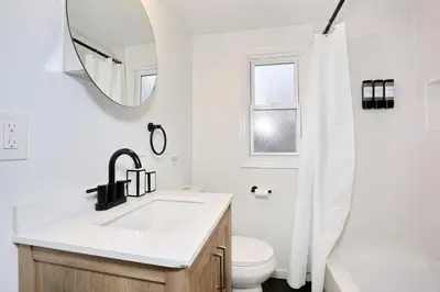 a white bathroom with a sink and a mirror at NEW Modern NYC Escape near MetLife AmDream MALL EWR in Bergenfield