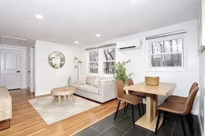 a living room with a table and a couch at NEW Modern NYC Escape near MetLife AmDream MALL EWR in Bergenfield