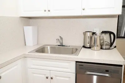 a kitchen counter with a sink and silver appliances at East2 Village Center Apartment7 w Full Amenities Great New York Location in New York