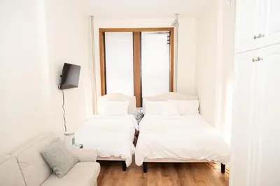 a living room with two beds and a couch at East2 Village Center Apartment7 w Full Amenities Great New York Location in New York