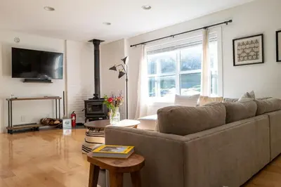 a living room with a couch and a table at Stylish Catskills Escape Near Town & Trails in Livingston Manor