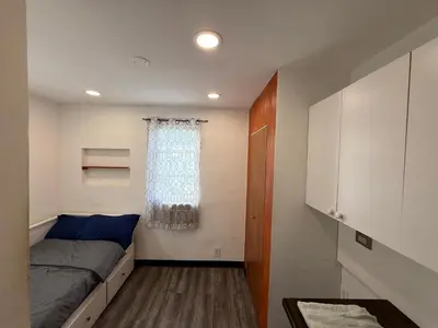 a small bedroom with a bed and a window at Classic Comfort Room Near LAGUARDIA AIRPORT in North Beach