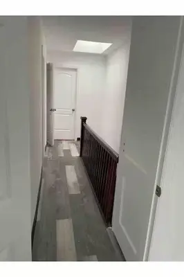 an empty hallway with a white door and a stair case at Classic Comfort Room Near LAGUARDIA AIRPORT in North Beach