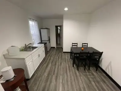 a kitchen and dining room with a table and chairs at Classic Comfort Room Near LAGUARDIA AIRPORT in North Beach