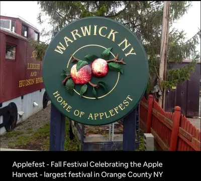 a sign for the apple harvest largest festival in orange county at Lakefront Haven on Greenwood Lake in West Milford