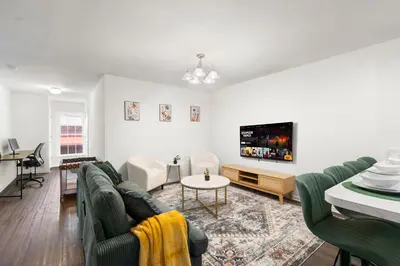 a living room with a couch and a tv at Traveler Haven XL NYC & NWK with free parking in Newark