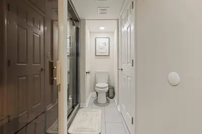a white bathroom with a toilet in a hallway at Pocono Chalet with Sauna/Hot Tub/Firepit/10+ Beds in Long Pond