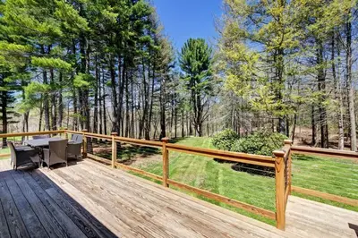 a wooden deck with a table and chairs on it at Cottage in the woods in Salisbury