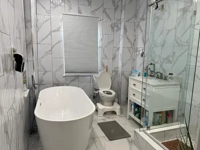 a bathroom with a tub and a toilet and a sink at Santa Cruz rooms and hospitality