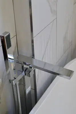 a chrome bathroom sink with aaucet at Santa Cruz rooms and hospitality