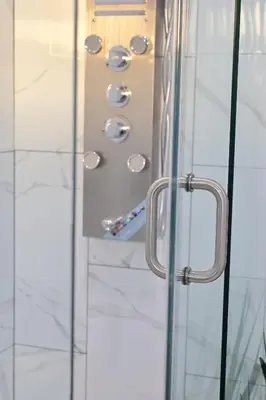a glass door with a handle in a bathroom at Santa Cruz rooms and hospitality
