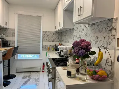 a kitchen with a vase of flowers on a counter at Santa Cruz rooms and hospitality