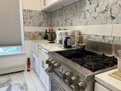 a kitchen with a stove top oven in a kitchen at Santa Cruz rooms and hospitality