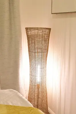 a lamp sitting next to a bed in a bedroom at Santa Cruz rooms and hospitality