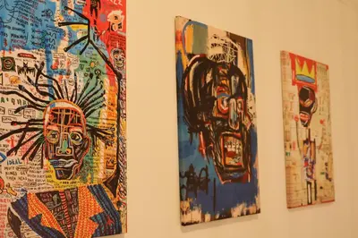 a group of paintings hanging on a wall at Santa Cruz rooms and hospitality