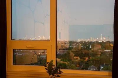a window with a view of a city at Luxury Lookout with NYC view, 2BR plus Free Parking, Sleeps 8, 20 Percent Off in East Orange