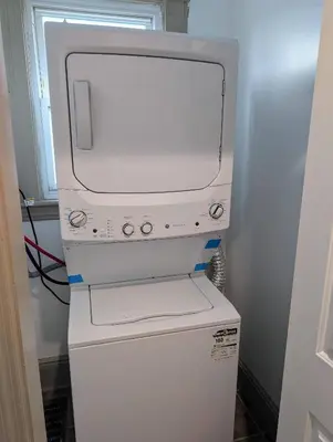 a white machine sitting on top of a refrigerator at Spacious duplex retreat in city w/ Parking nearby in Jersey City