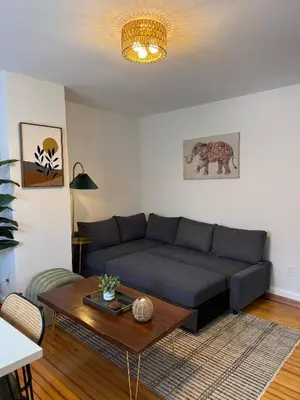 a living room with a couch and a table at Sunset Slopes in Jersey City