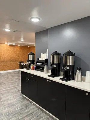 a waiting room with a counter with coffee machines at Bklyn House Hotel New York Brooklyn in Brooklyn