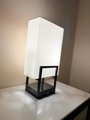 a white lamp sitting on top of a table at Nova Hotel Bronx in Melrose
