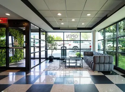 a lobby with a couch and a table in a building at Nova Hotel Bronx in Melrose