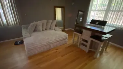 a living room with a white couch and a desk at VIP Pocono Escape Water Park,Casino,All Inclusive in East Stroudsburg