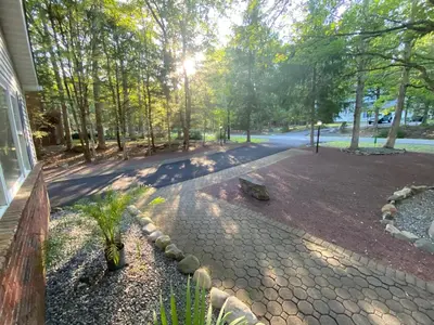 a walkway in a park next to a house at VIP Pocono Escape Water Park,Casino,All Inclusive in East Stroudsburg