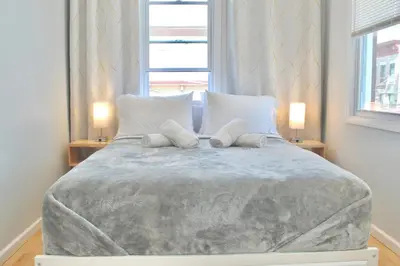 a bedroom with a bed with two pillows on it at 15 Minutes From Manhattan 2-Bedroom Apartment in LIC Astoria Queens