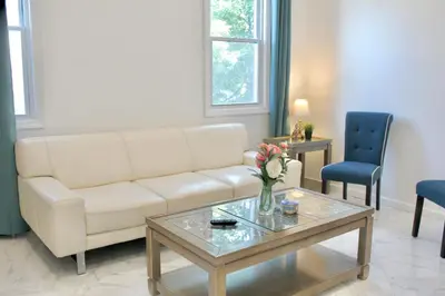 a living room with a couch and a table at 15 Minutes From Manhattan 2-Bedroom Apartment in LIC Astoria Queens