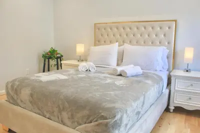 a bedroom with a large bed with towels on it at 2-Bedroom Apartment 15 Minutes From Manhattan in LIC Astoria Queens