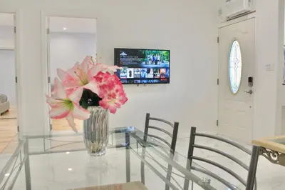 a vase of flowers sitting on a glass table at 2-Bedroom Apartment 15 Minutes From Manhattan in LIC Astoria Queens