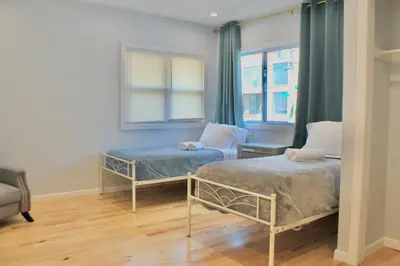 a bedroom with two beds and a window at 2-Bedroom Apartment 15 Minutes From Manhattan in LIC Astoria Queens