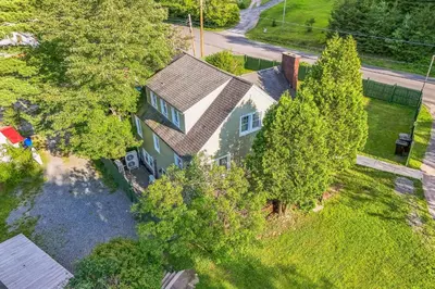 an overhead view of a house with trees at Cozy Cottage House - Pool & Hot Tub in Liberty