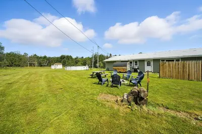 a group of chairs sitting in a yard at Liberty Lakefront Home - Pool, Hot Tub, Sauna in Liberty