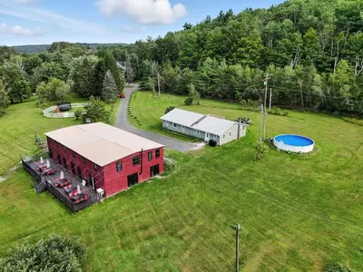 an aerial view of a red barn in a field at Liberty Lakefront Home - Pool, Hot Tub, Sauna in Liberty