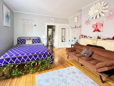 a bedroom with a bed and a couch in it at Historic Studio Near Trinity College with Fast WiFi in Hartford