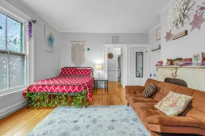 a living room with a couch and a bed at Historic Studio Near Trinity College with Fast WiFi in Hartford