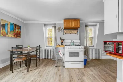 a kitchen with a table and a white stove top oven at Historic Studio Near Trinity College with Fast WiFi in Hartford