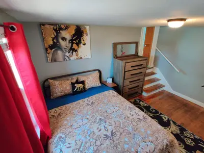 a bedroom with a bed and a dresser at City Charm Walk to Trinity & Hospital with Parking in Hartford