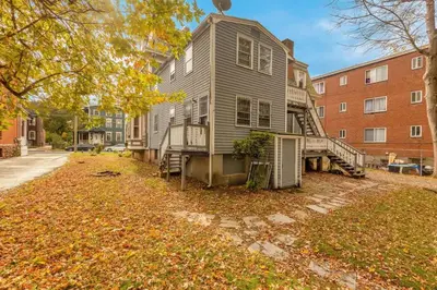 a gray house with a staircase in a yard at City Charm Walk to Trinity & Hospital with Parking in Hartford
