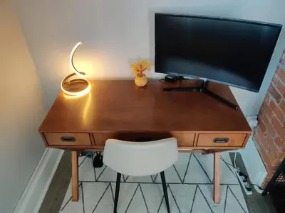 a desk with a computer monitor and a white chair at City Charm Walk to Trinity & Hospital with Parking in Hartford