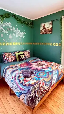 a bedroom with a bed with a colorful comforter at Enchanting 3BR Near Downtown Hartford Cozy & Modern with Parking in Hartford