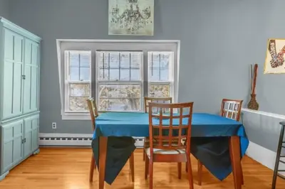 a dining room with a blue table and chairs at Enchanting 3BR Near Downtown Hartford Cozy & Modern with Parking in Hartford