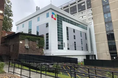 a building with a sign on the side of it at Enchanting 3BR Near Downtown Hartford Cozy & Modern with Parking in Hartford