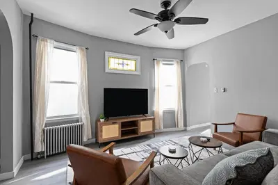 a living room with a couch and a flat screen tv at Cozy Home, 19 min to NYC, 3 Car Driveway in Wallington